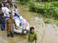 Volunteers and Bangladesh army personnel transport relief material for flood-affected people in Feni district in Chittagong division, Bangla...