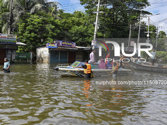 Volunteers help local people transport from one place to another in Feni district in Chittagong division, Bangladesh, on August 24, 2024. (