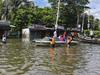 Volunteers help local people transport from one place to another in Feni district in Chittagong division, Bangladesh, on August 24, 2024. (