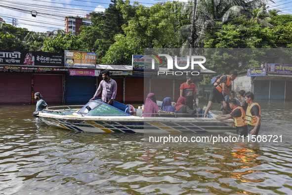 Volunteers help local people transport from one place to another in Feni district in Chittagong division, Bangladesh, on August 24, 2024. 