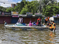 Volunteers help local people transport from one place to another in Feni district in Chittagong division, Bangladesh, on August 24, 2024. (