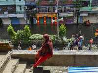 A woman takes temporary shelter at an under-construction building in the Feni district in Chittagong division, Bangladesh, on August 24, 202...