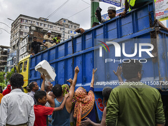 Local people want relief from volunteers in Feni district in Chittagong division, Bangladesh, on August 24, 2024. (