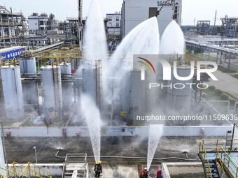 Firefighters participate in a rescue drill at a chemical company in Huai'an, Jiangsu province, China, on August 25, 2024. (