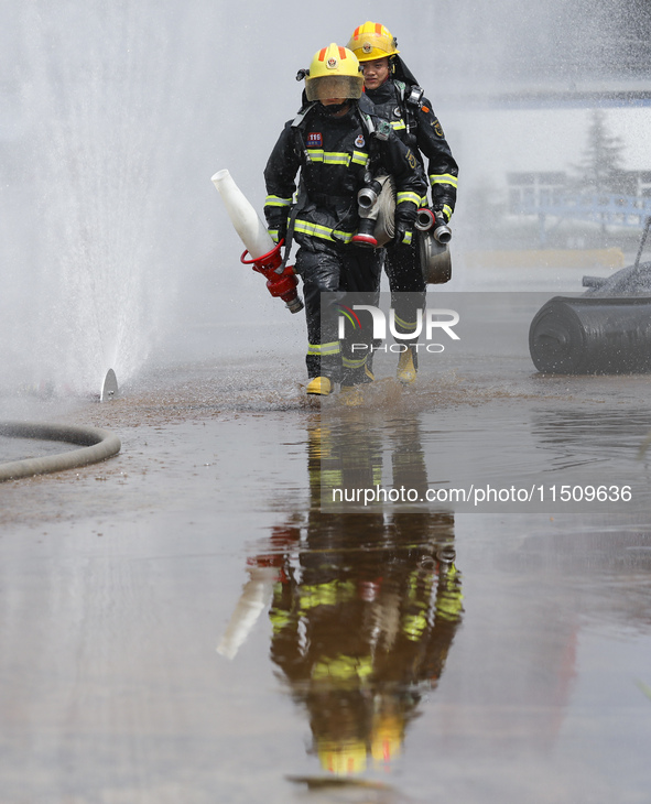 Firefighters participate in a rescue drill at a chemical company in Huai'an, Jiangsu province, China, on August 25, 2024. 