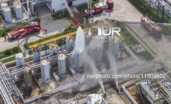 Firefighters participate in a rescue drill at a chemical company in Huai'an, Jiangsu province, China, on August 25, 2024. 