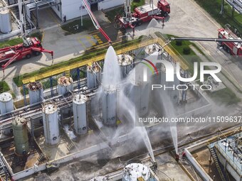 Firefighters participate in a rescue drill at a chemical company in Huai'an, Jiangsu province, China, on August 25, 2024. (