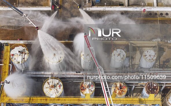 Firefighters participate in a rescue drill at a chemical company in Huai'an, Jiangsu province, China, on August 25, 2024. 