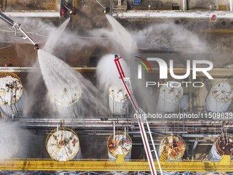 Firefighters participate in a rescue drill at a chemical company in Huai'an, Jiangsu province, China, on August 25, 2024. (