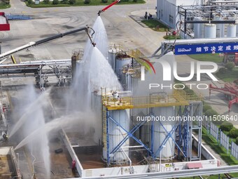 Firefighters participate in a rescue drill at a chemical company in Huai'an, Jiangsu province, China, on August 25, 2024. (