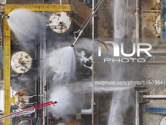 Firefighters participate in a rescue drill at a chemical company in Huai'an, Jiangsu province, China, on August 25, 2024. (