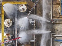 Firefighters participate in a rescue drill at a chemical company in Huai'an, Jiangsu province, China, on August 25, 2024. (