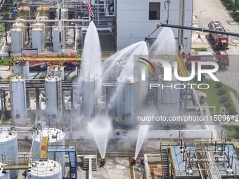 Firefighters participate in a rescue drill at a chemical company in Huai'an, Jiangsu province, China, on August 25, 2024. (