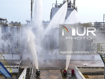 Firefighters participate in a rescue drill at a chemical company in Huai'an, Jiangsu province, China, on August 25, 2024. (