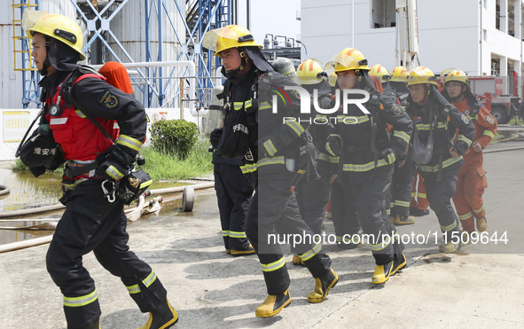 Firefighters participate in a rescue drill at a chemical company in Huai'an, Jiangsu province, China, on August 25, 2024. 