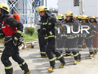 Firefighters participate in a rescue drill at a chemical company in Huai'an, Jiangsu province, China, on August 25, 2024. (