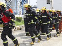 Firefighters participate in a rescue drill at a chemical company in Huai'an, Jiangsu province, China, on August 25, 2024. (