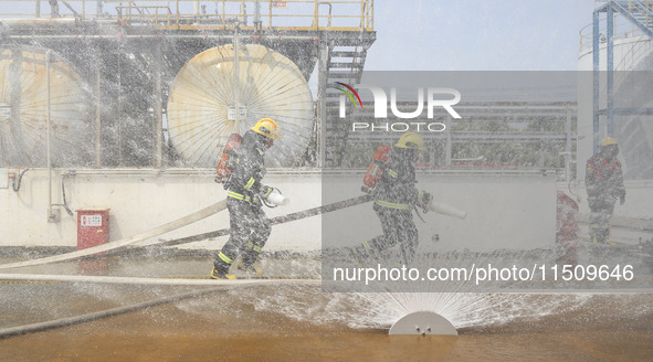 Firefighters participate in a rescue drill at a chemical company in Huai'an, Jiangsu province, China, on August 25, 2024. 