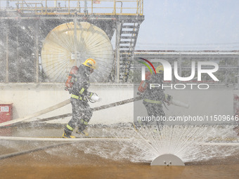 Firefighters participate in a rescue drill at a chemical company in Huai'an, Jiangsu province, China, on August 25, 2024. (