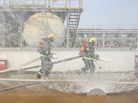 Firefighters participate in a rescue drill at a chemical company in Huai'an, Jiangsu province, China, on August 25, 2024. (