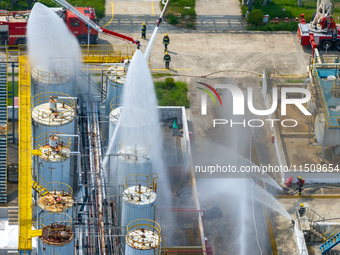 Firefighters participate in a rescue drill at a chemical company in Huai'an, Jiangsu province, China, on August 25, 2024. (