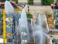 Firefighters participate in a rescue drill at a chemical company in Huai'an, Jiangsu province, China, on August 25, 2024. (