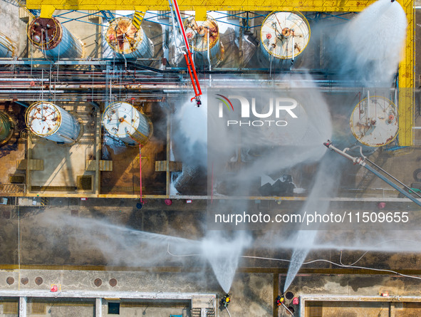 Firefighters participate in a rescue drill at a chemical company in Huai'an, Jiangsu province, China, on August 25, 2024. 