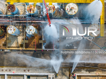 Firefighters participate in a rescue drill at a chemical company in Huai'an, Jiangsu province, China, on August 25, 2024. (