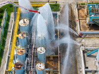 Firefighters participate in a rescue drill at a chemical company in Huai'an, Jiangsu province, China, on August 25, 2024. (