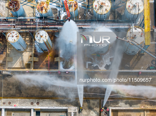 Firefighters participate in a rescue drill at a chemical company in Huai'an, Jiangsu province, China, on August 25, 2024. 