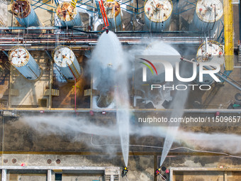 Firefighters participate in a rescue drill at a chemical company in Huai'an, Jiangsu province, China, on August 25, 2024. (