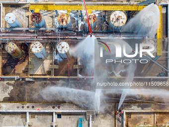 Firefighters participate in a rescue drill at a chemical company in Huai'an, Jiangsu province, China, on August 25, 2024. (