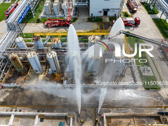 Firefighters participate in a rescue drill at a chemical company in Huai'an, Jiangsu province, China, on August 25, 2024. (