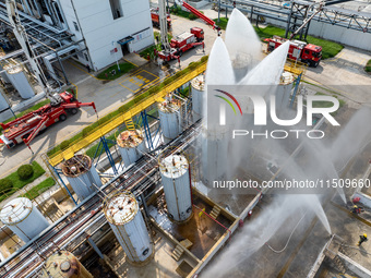 Firefighters participate in a rescue drill at a chemical company in Huai'an, Jiangsu province, China, on August 25, 2024. (