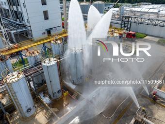 Firefighters participate in a rescue drill at a chemical company in Huai'an, Jiangsu province, China, on August 25, 2024. (