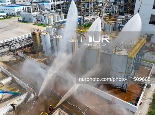 Firefighters participate in a rescue drill at a chemical company in Huai'an, Jiangsu province, China, on August 25, 2024. 