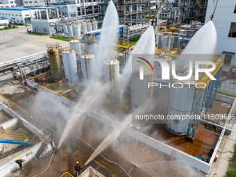 Firefighters participate in a rescue drill at a chemical company in Huai'an, Jiangsu province, China, on August 25, 2024. (