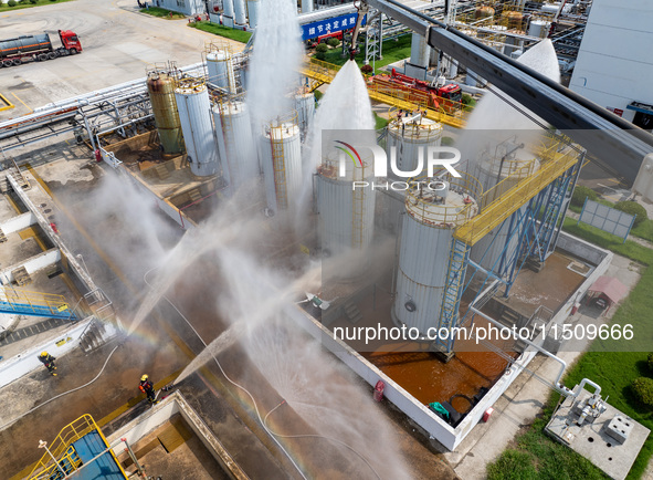 Firefighters participate in a rescue drill at a chemical company in Huai'an, Jiangsu province, China, on August 25, 2024. 