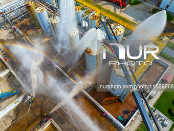 Firefighters participate in a rescue drill at a chemical company in Huai'an, Jiangsu province, China, on August 25, 2024. (