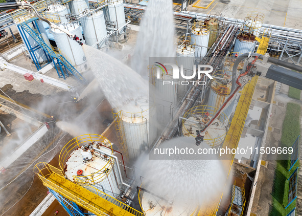 Firefighters participate in a rescue drill at a chemical company in Huai'an, Jiangsu province, China, on August 25, 2024. 