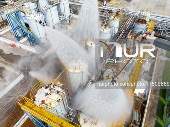 Firefighters participate in a rescue drill at a chemical company in Huai'an, Jiangsu province, China, on August 25, 2024. (