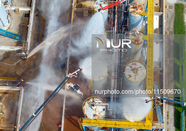 Firefighters participate in a rescue drill at a chemical company in Huai'an, Jiangsu province, China, on August 25, 2024. 