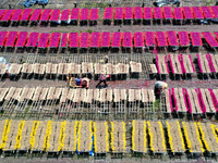 A worker dries incense on the drying field of a fragrance-making enterprise in Quanzhou, China, on August 25, 2024. (