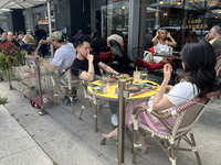 People dine on an outdoor restaurant patio in Toronto, Ontario, Canada, on August 24, 2024. (