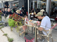 People dine on an outdoor restaurant patio in Toronto, Ontario, Canada, on August 24, 2024. (