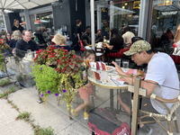 People dine at an outdoor restaurant patio in Toronto, Ontario, Canada, on August 24, 2024. (