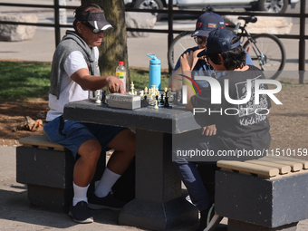 People play chess at Nathan Philips Square in downtown Toronto, Ontario, Canada, on August 14, 2024. (