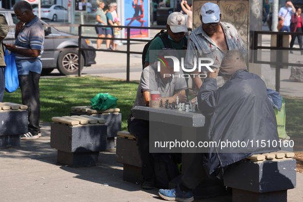 People play chess at Nathan Philips Square in downtown Toronto, Ontario, Canada, on August 14, 2024. 