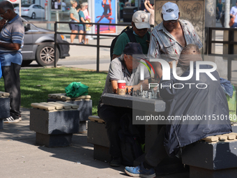 People play chess at Nathan Philips Square in downtown Toronto, Ontario, Canada, on August 14, 2024. (