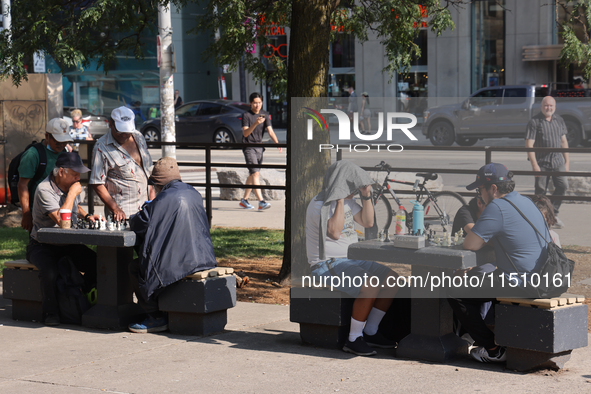 People play chess at Nathan Philips Square in downtown Toronto, Ontario, Canada, on August 14, 2024. 